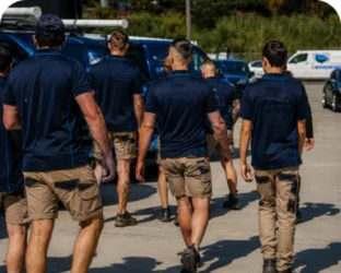 Plumbers walking to their service vans on a Pyrmont job